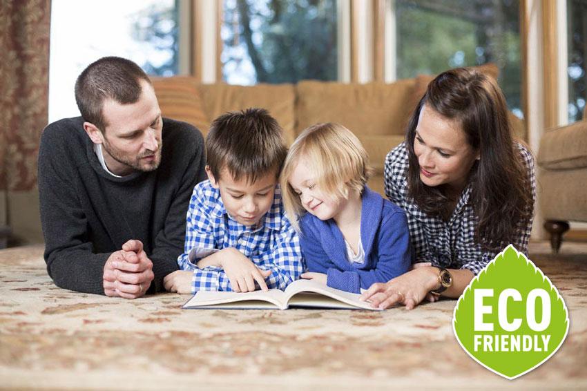 Family reading book on the floor